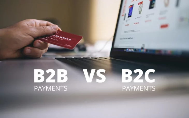 Hand with credit card for B2B or B2C payment in front of computer