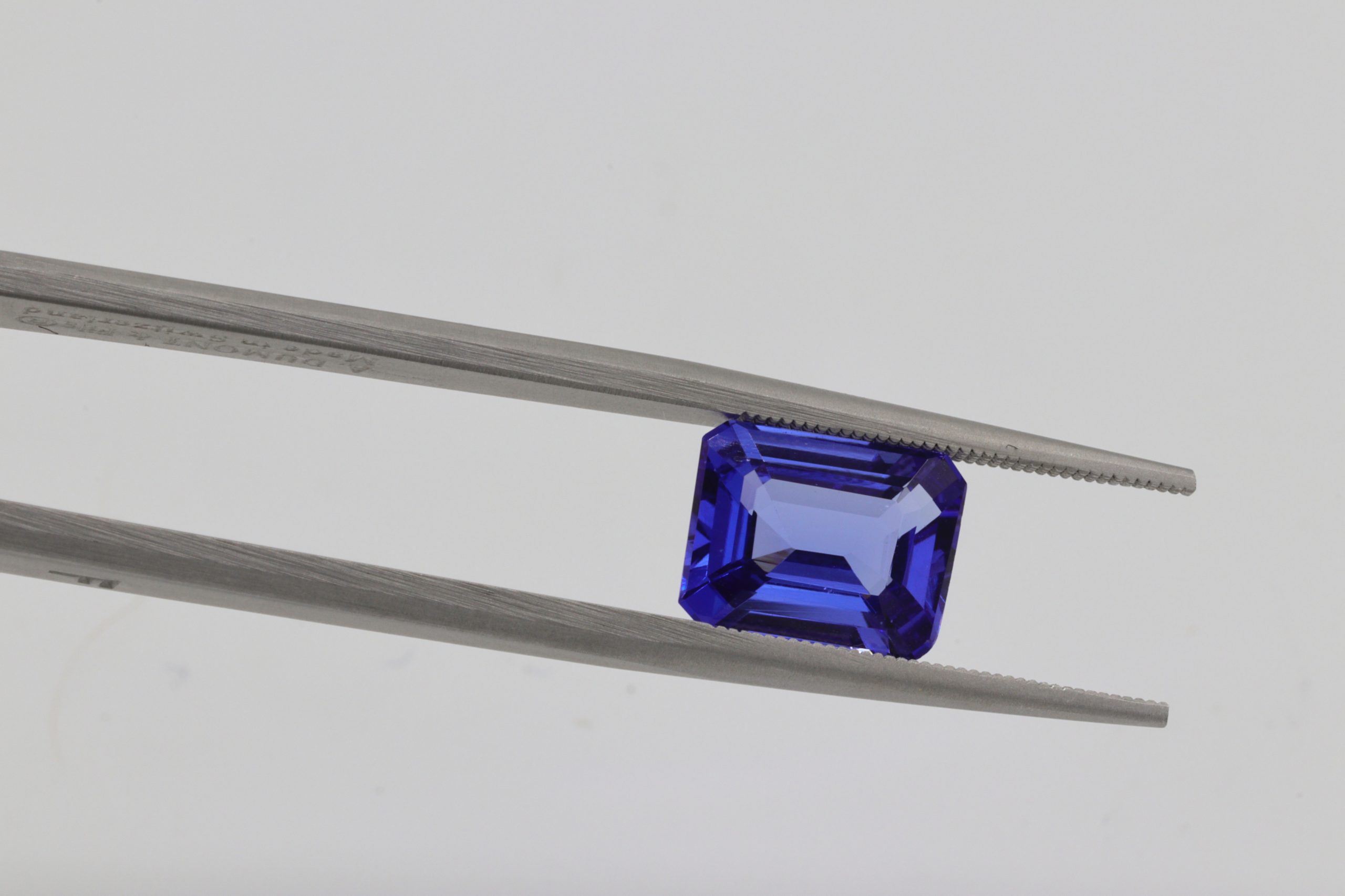 tweezers holding a gemstone