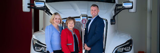 Rihm Kenworth team in front of a Kenworth truck