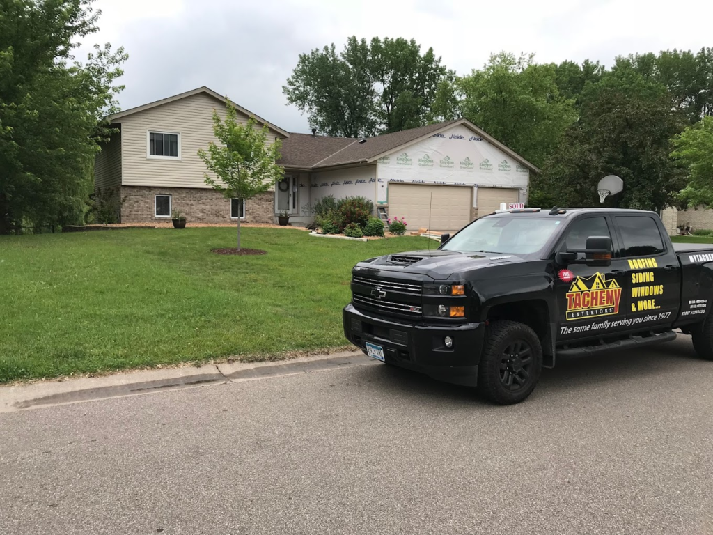 Tacheny Exteriors work truck in front of house